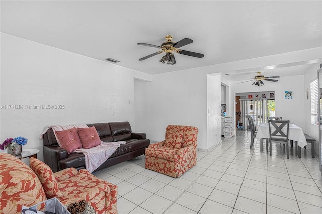 tiled living room with ceiling fan