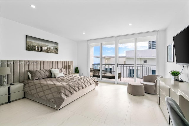 bedroom featuring expansive windows and access to exterior