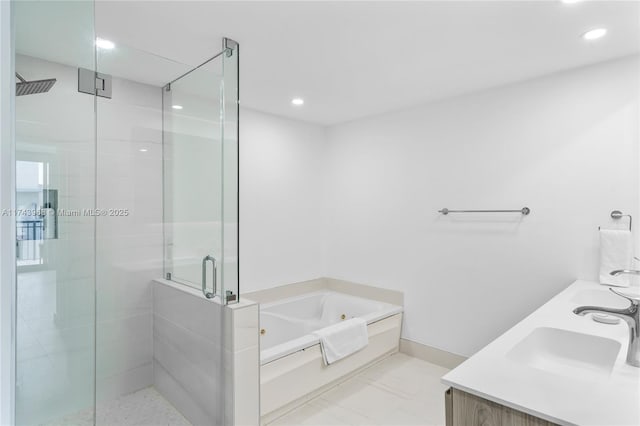 bathroom featuring vanity and shower with separate bathtub