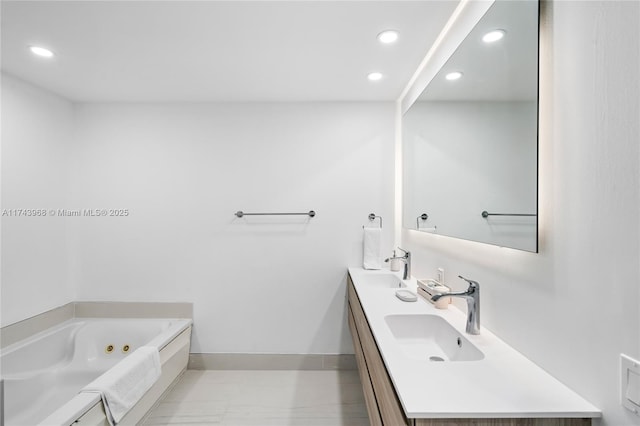 bathroom with a tub to relax in and vanity