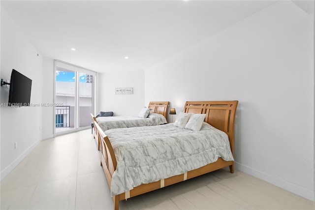 bedroom with floor to ceiling windows and access to outside