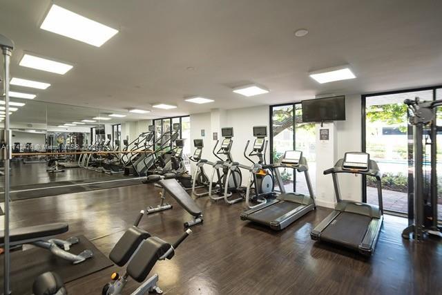 3300 NE 192nd St Unit 111, Aventura, FL 33180 - gym with plenty of natural light and wood finished floors