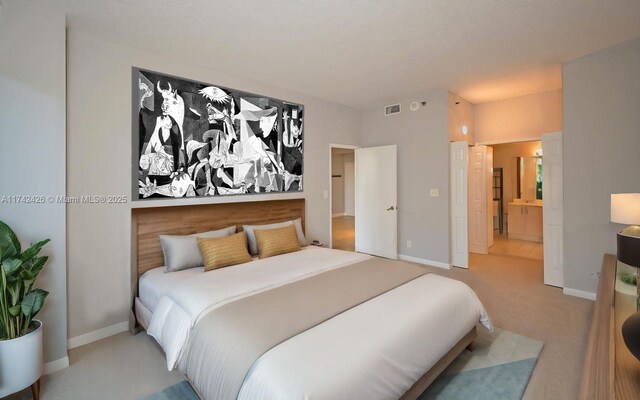 3300 NE 192nd St Unit 111, Aventura, FL 33180 - bedroom with carpet floors, baseboards, and ensuite bath