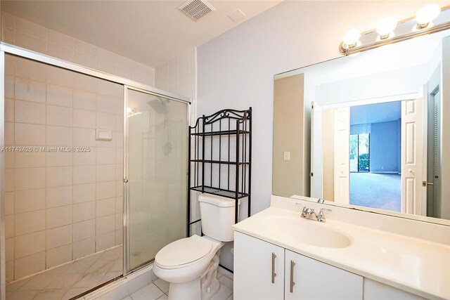 3300 NE 192nd St Unit 111, Aventura, FL 33180 - bathroom featuring toilet, vanity, a stall shower, and tile patterned flooring