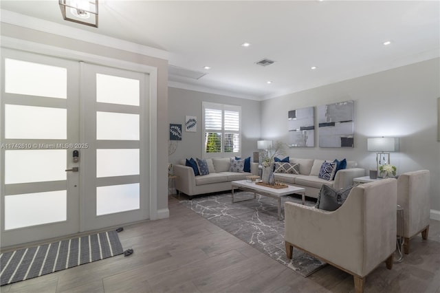 living room with ornamental molding and wood-type flooring