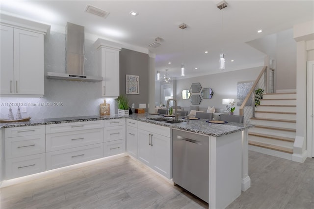 kitchen with white cabinetry, wall chimney range hood, decorative light fixtures, and black electric cooktop