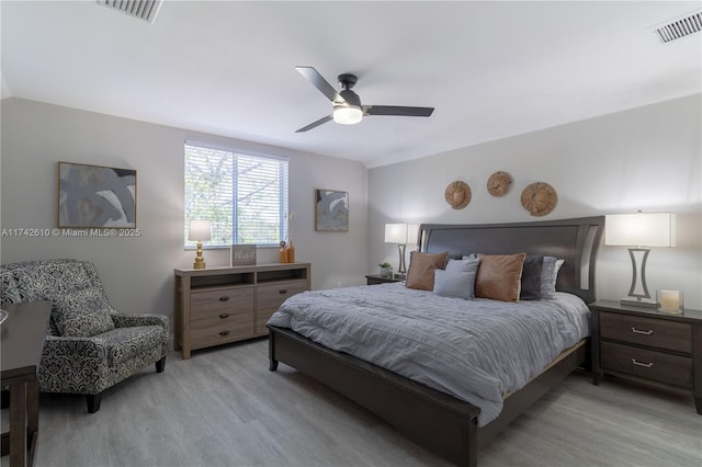 bedroom with ceiling fan and light hardwood / wood-style flooring