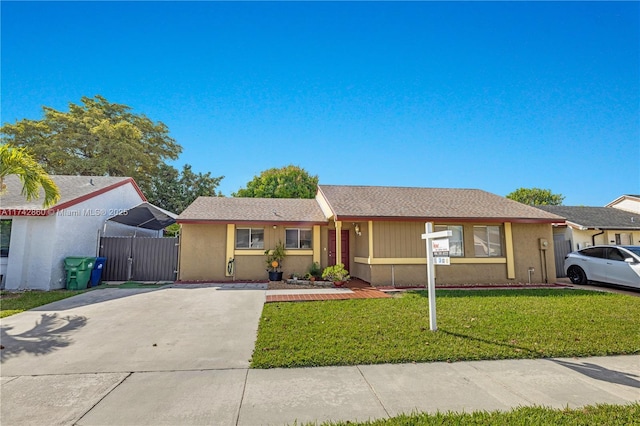 single story home featuring a front lawn