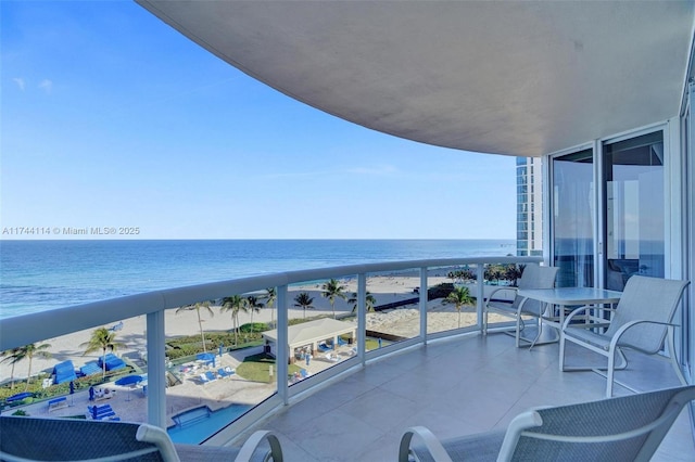 balcony with a beach view and a water view