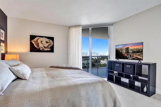 carpeted bedroom featuring a wall of windows