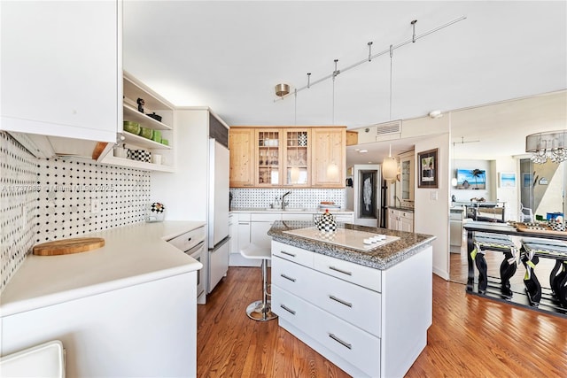 2555 Collins Ave Unit 607, Miami Beach, FL 33140 - kitchen with built in refrigerator, a center island, wood finished floors, and white electric cooktop