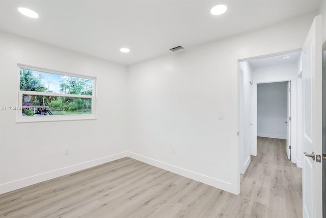 unfurnished room with light hardwood / wood-style floors