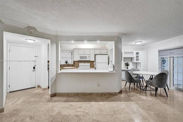 kitchen with white appliances, crown molding, white cabinetry, a textured ceiling, and kitchen peninsula