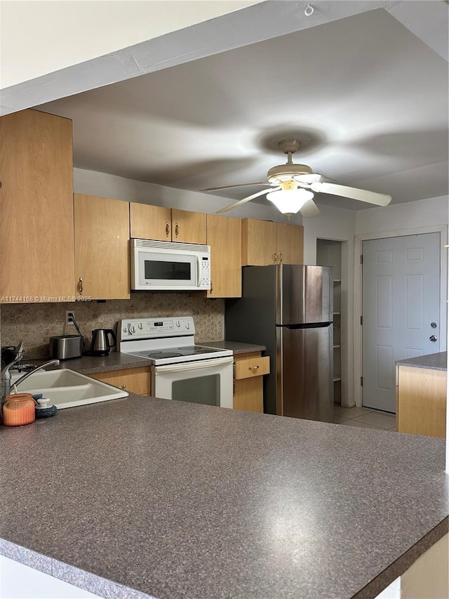 1750 NE 191st St Unit 225-4, Miami, FL 33179 - kitchen featuring sink, white appliances, ceiling fan, tasteful backsplash, and kitchen peninsula