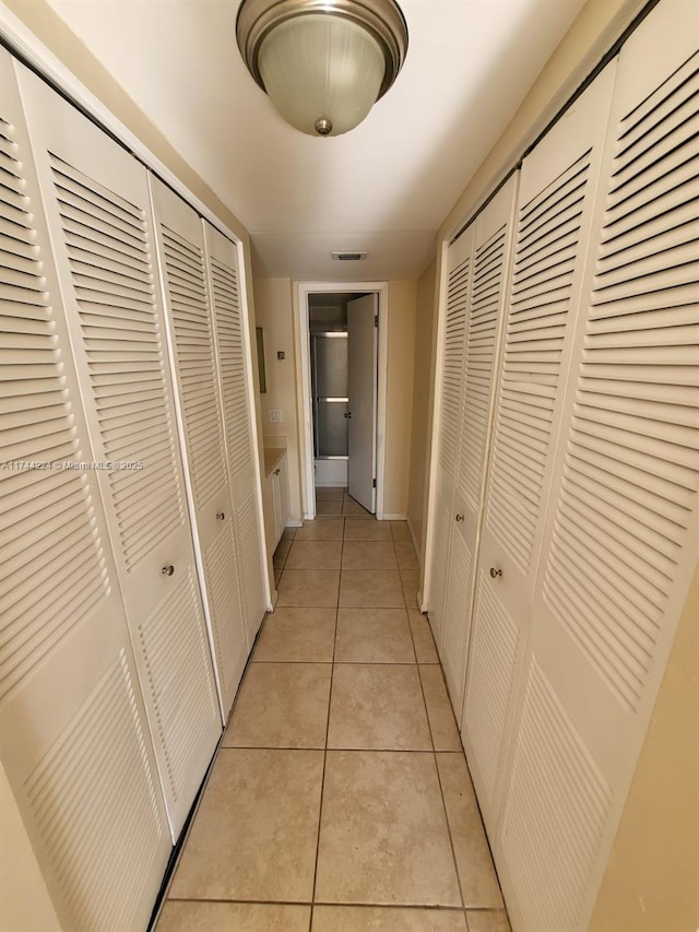 hallway featuring light tile patterned flooring