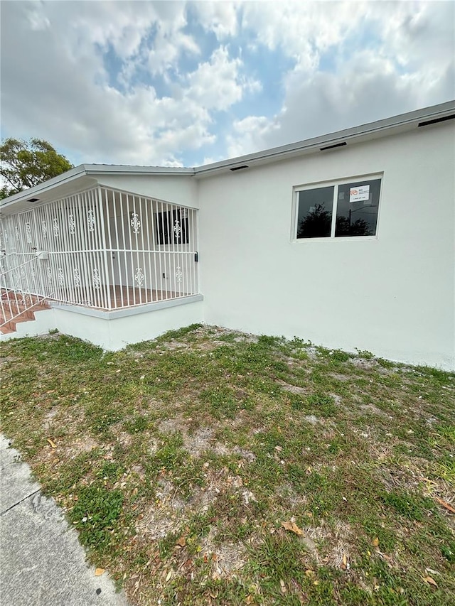 view of side of home featuring a yard