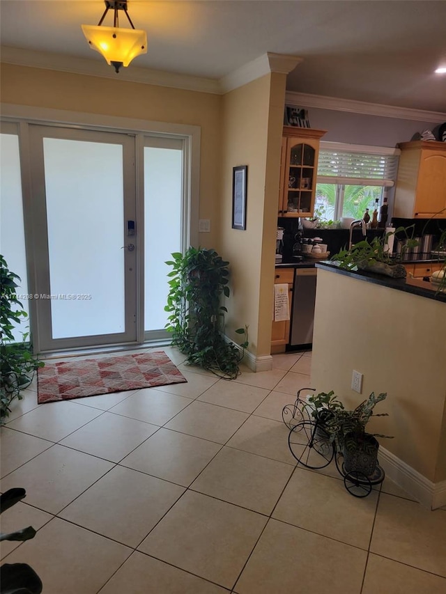 kitchen with crown molding, decorative backsplash, light tile patterned flooring, and dishwasher