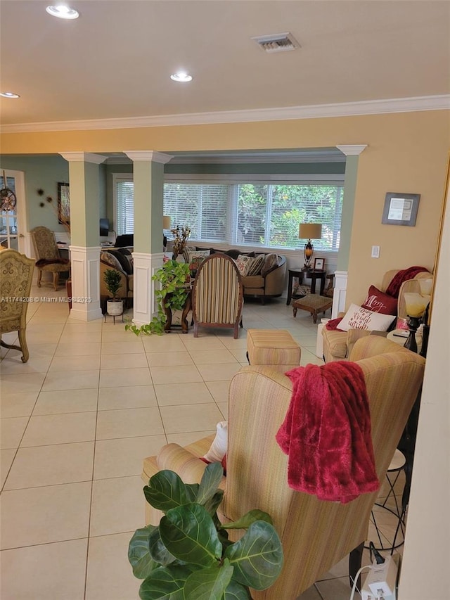 tiled living room featuring crown molding and ornate columns