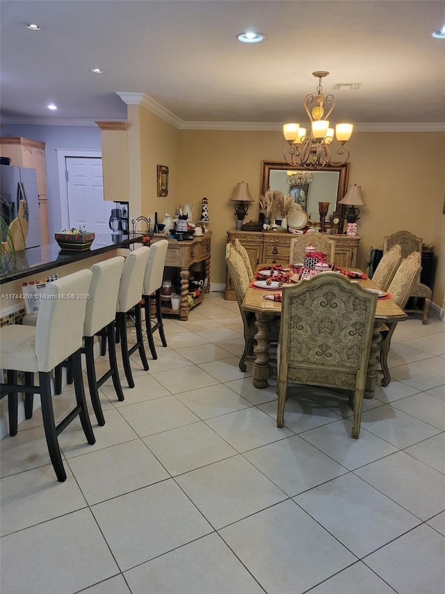 dining room with crown molding, a chandelier, and light tile patterned flooring