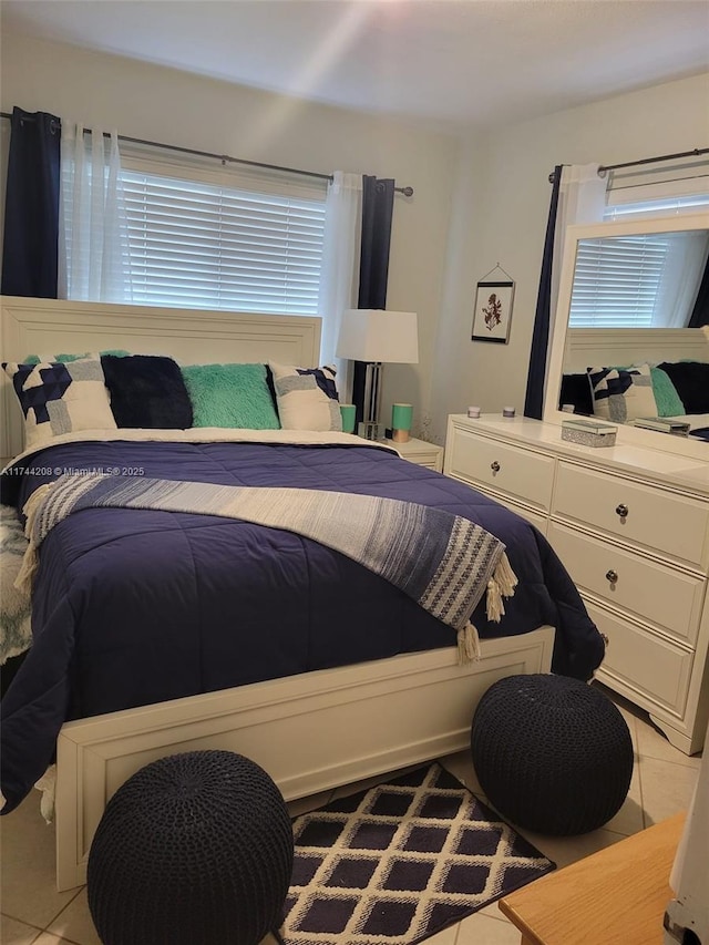 bedroom with multiple windows and light tile patterned floors