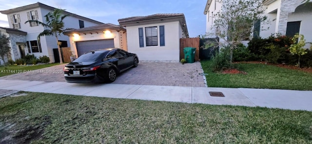 view of front of house featuring a garage and a front lawn