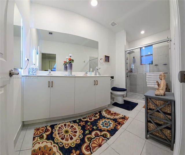 bathroom with visible vents, a shower stall, toilet, double vanity, and tile patterned floors