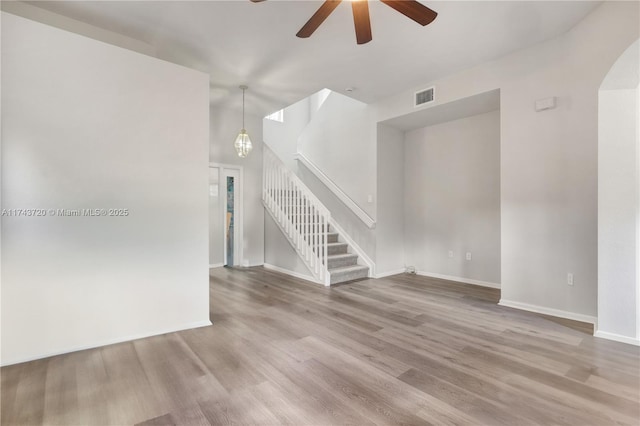 7459 NW 17th Dr, Pembroke Pines, FL 33024 - spare room with a ceiling fan, wood finished floors, stairs, and arched walkways