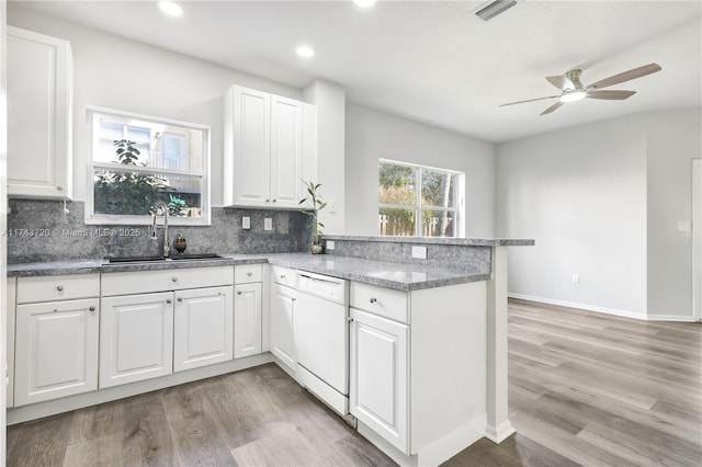 7459 NW 17th Dr, Pembroke Pines, FL 33024 - kitchen with dishwasher, ceiling fan, a peninsula, decorative backsplash, and light wood-type flooring