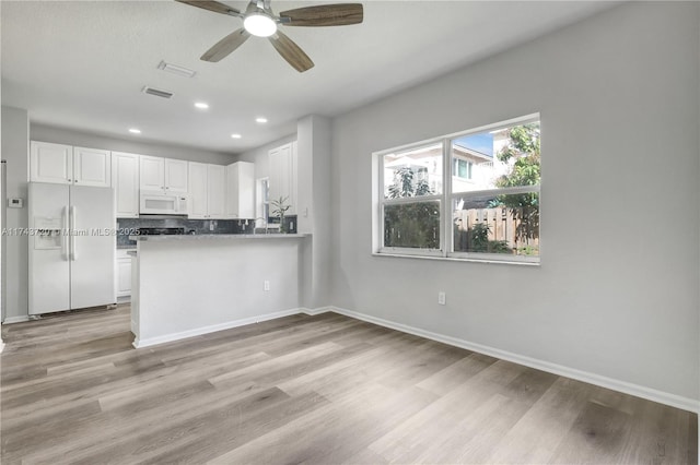 7459 NW 17th Dr, Pembroke Pines, FL 33024 - kitchen featuring white appliances, white cabinets, ceiling fan, light wood-style flooring, and recessed lighting