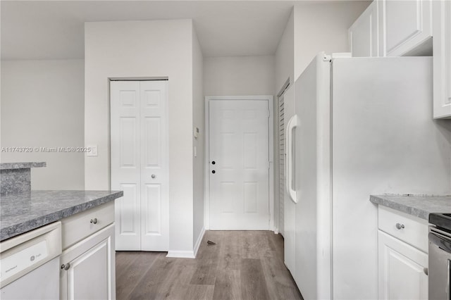 7459 NW 17th Dr, Pembroke Pines, FL 33024 - kitchen with white appliances, wood finished floors, and white cabinets