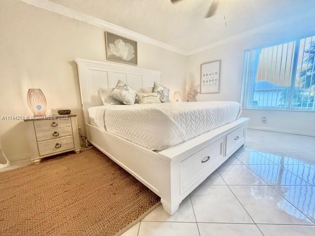 tiled bedroom featuring ornamental molding and ceiling fan