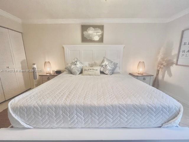 bedroom featuring ornamental molding and a closet