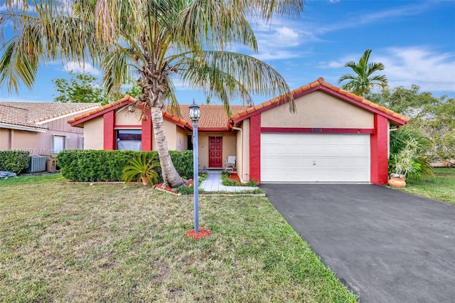 5911 Epsom Ln, Davie, FL 33331 - view of front of home featuring a garage, driveway, a tiled roof, central AC unit, and a front lawn