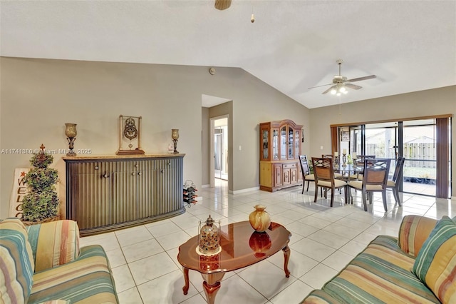 living room featuring lofted ceiling, light tile patterned floors, and ceiling fan