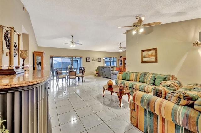 tiled living room featuring lofted ceiling and a textured ceiling