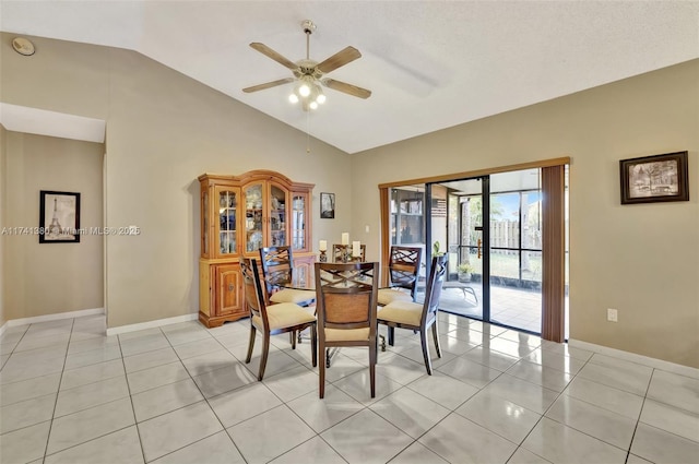 tiled dining room with vaulted ceiling and ceiling fan