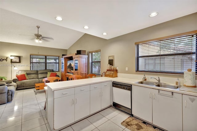 kitchen featuring white cabinetry, dishwasher, sink, light tile patterned floors, and kitchen peninsula