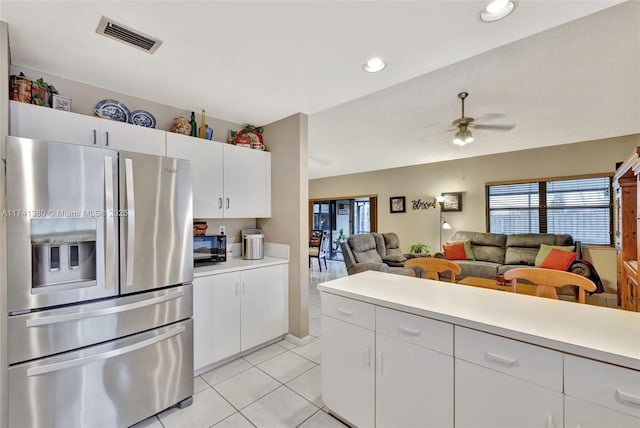 kitchen featuring light tile patterned flooring, ceiling fan, stainless steel fridge with ice dispenser, and white cabinets