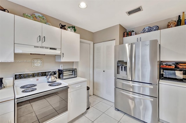 5911 Epsom Ln, Davie, FL 33331 - kitchen with stainless steel fridge, white electric stove, under cabinet range hood, light countertops, and light tile patterned floors