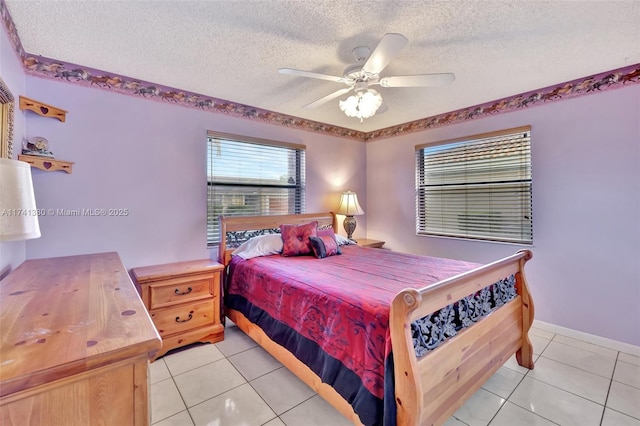 bedroom featuring light tile patterned floors, a textured ceiling, and ceiling fan