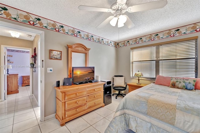 bedroom with light tile patterned floors, a textured ceiling, and ceiling fan