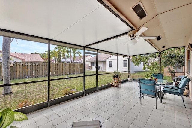 sunroom / solarium featuring ceiling fan