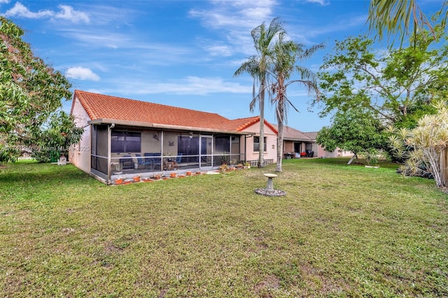 5911 Epsom Ln, Davie, FL 33331 - rear view of house featuring a lawn, a sunroom, and a tiled roof