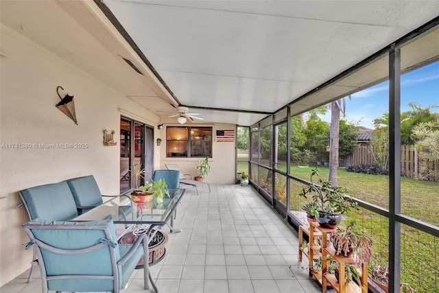 sunroom featuring ceiling fan