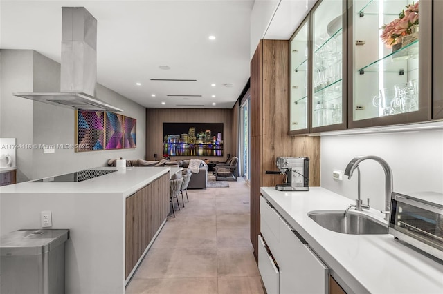 285 W Mashta Dr, Key Biscayne, FL 33149 - kitchen with island exhaust hood, black electric stovetop, light countertops, a sink, and modern cabinets