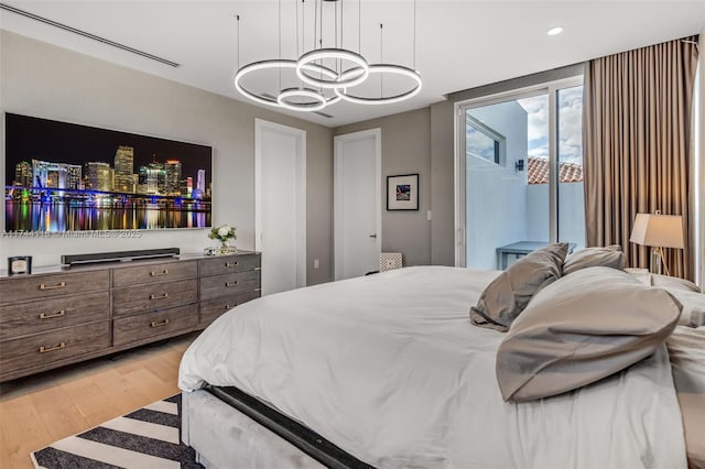 285 W Mashta Dr, Key Biscayne, FL 33149 - bedroom featuring light wood-type flooring, a chandelier, recessed lighting, and access to exterior