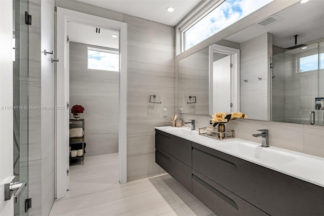 285 W Mashta Dr, Key Biscayne, FL 33149 - full bath featuring double vanity, a stall shower, tile walls, tile patterned flooring, and recessed lighting