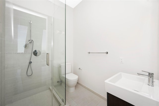 bathroom with vanity, a shower with shower door, and toilet