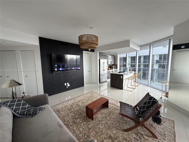 living area featuring light tile patterned floors and a wall of windows