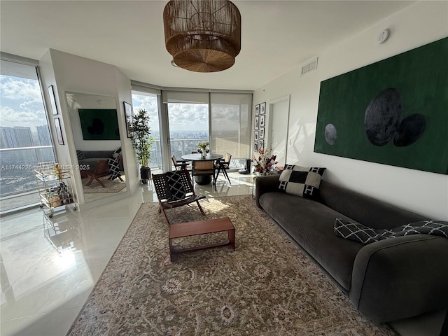 living room featuring a wall of windows, visible vents, and tile patterned floors